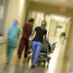 emergency room hallway with bed and nurses